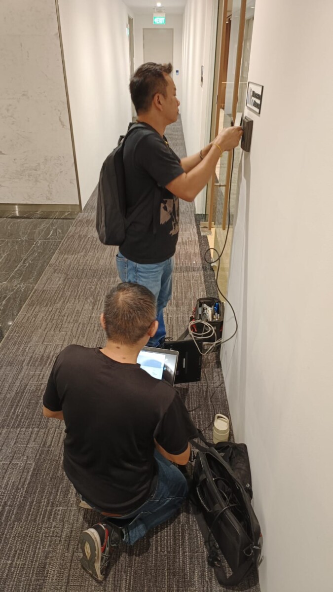 Engineer configuring door access system on site in Singapore